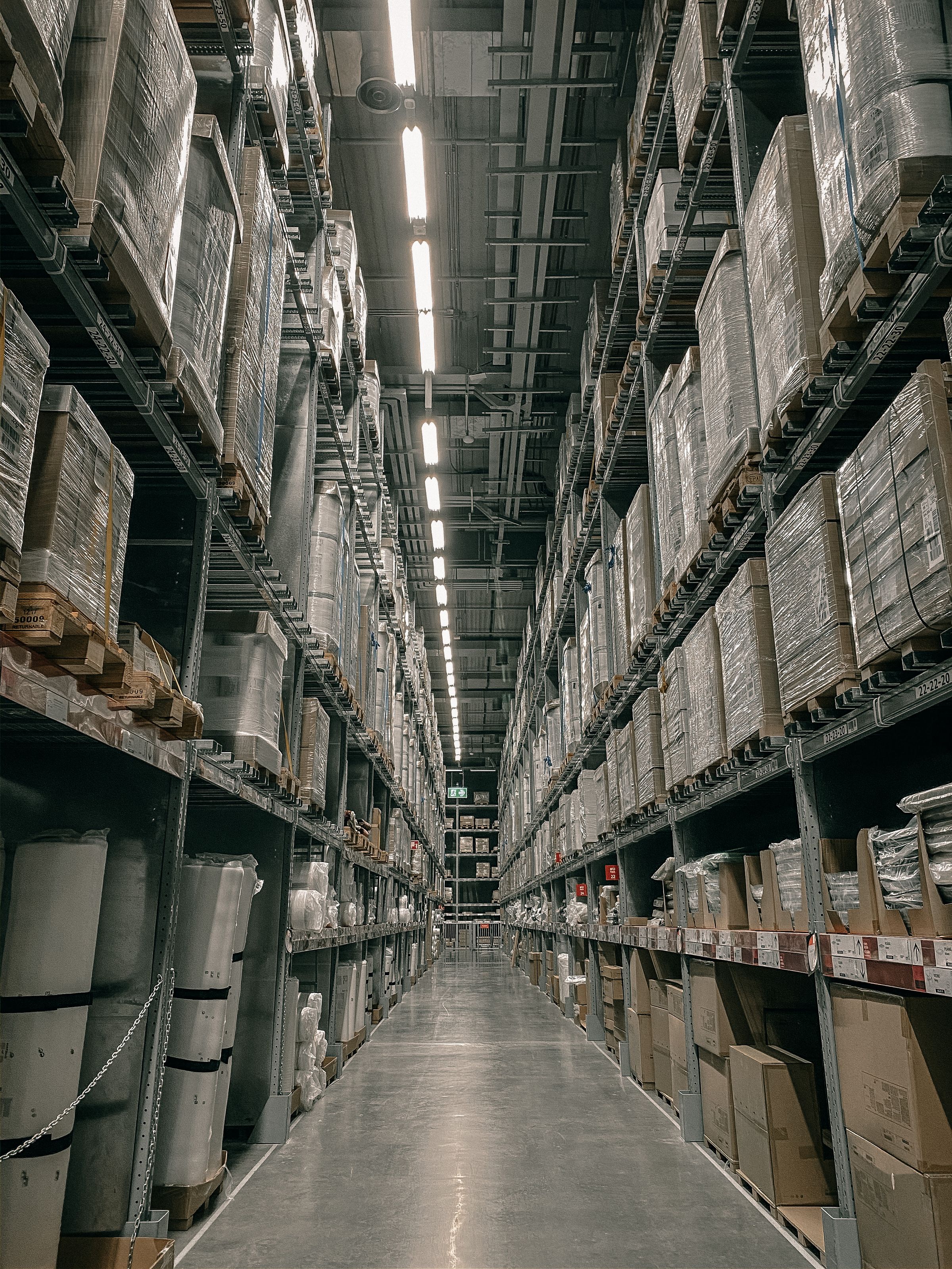 Long warehouse aisle with high shelving