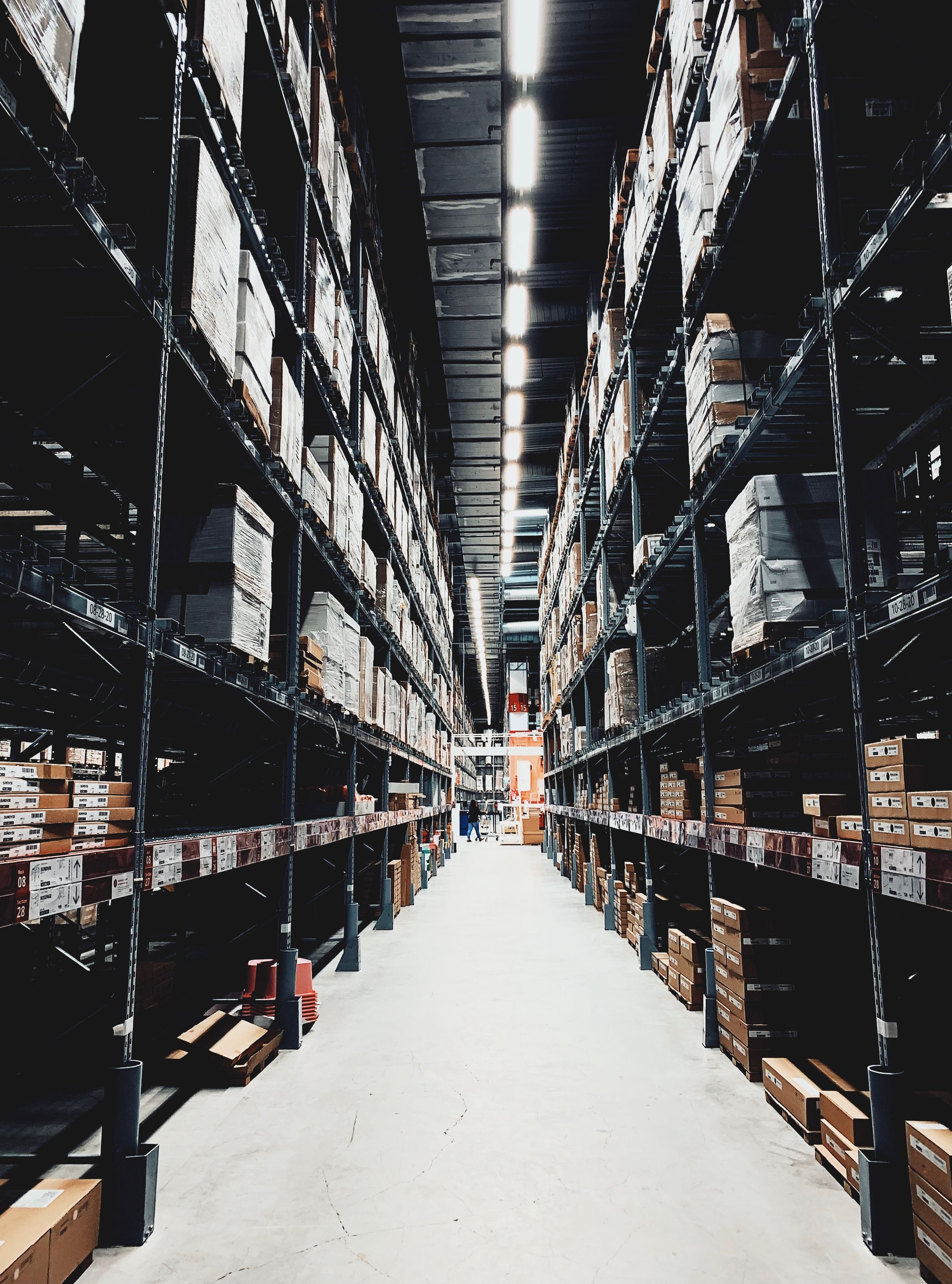 Wide warehouse aisle with boxes on high shelves
